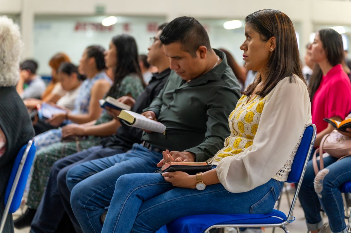 A congregation seated with open Bibles during a study