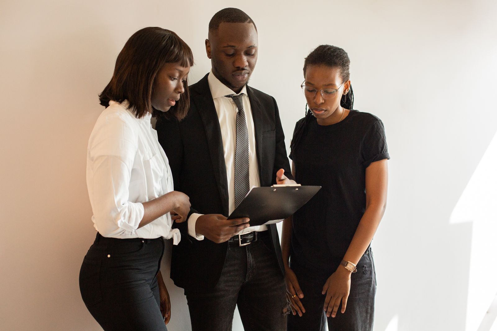 Three colleagues reviewing plans together
